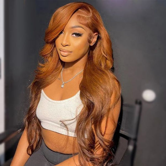 lady with long ginger hair wearing crown royale hair bundles and a deep side parting sitting on a chair with a white tank top and grey leggings 
