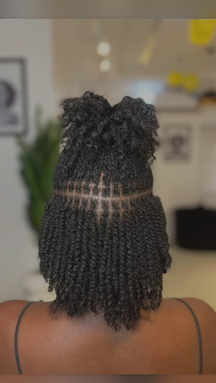 woman displaying natural twists on her hair backward facing 