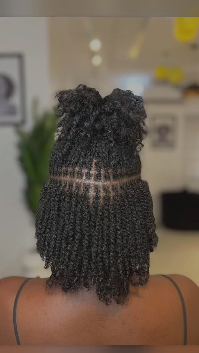 woman displaying natural twists on her hair backward facing 