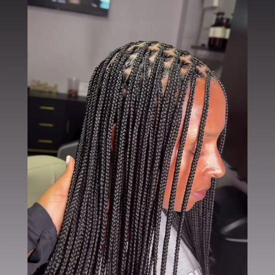 small sized mid back length knotless braids in black colour 