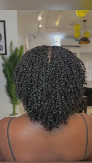 woman displaying natural twists on her hair backward facing 