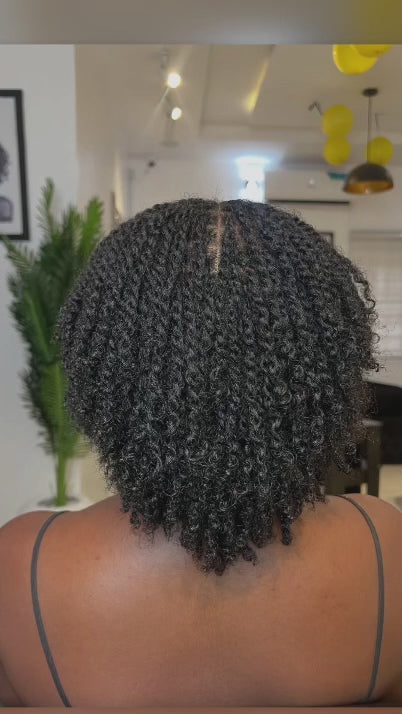 woman displaying natural twists on her hair backward facing 