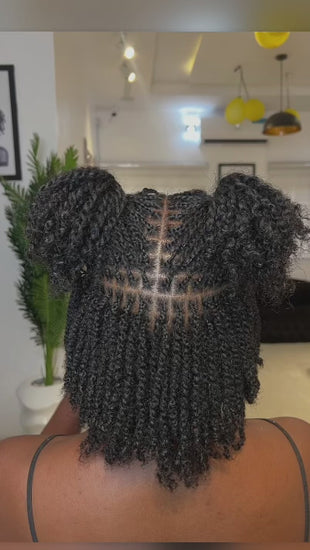 woman displaying natural twists on her hair backward facing 