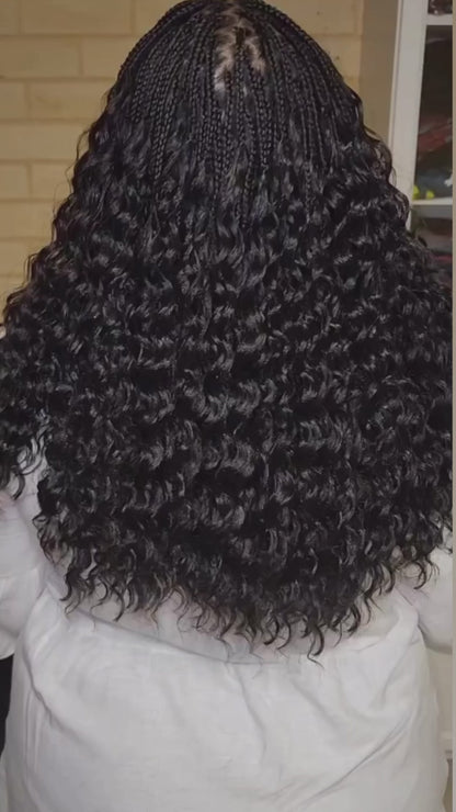 lady showing off her curly pick and drop from the back. She used crown royale hair braiding bundles in deep wave