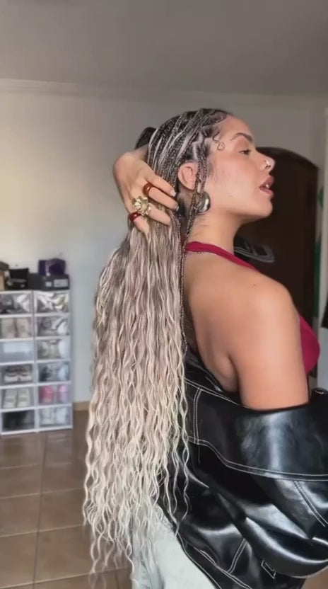 video showing woman in waist length platinum blonde medium sized boho braids