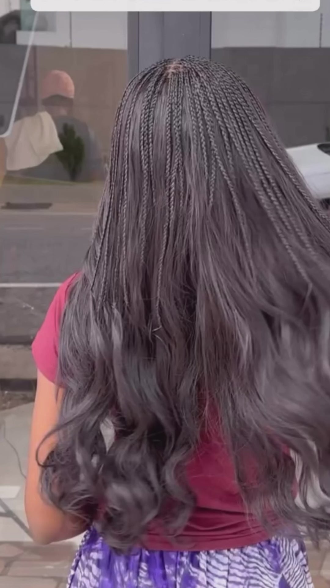 lady showing off her long wavy body wave human hair bundles from crown royale hair in 24 inches she has the top partof her braided in small braids