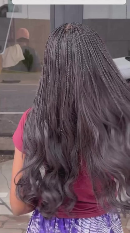 lady showing off her long wavy body wave human hair bundles from crown royale hair in 24 inches she has the top partof her braided in small braids
