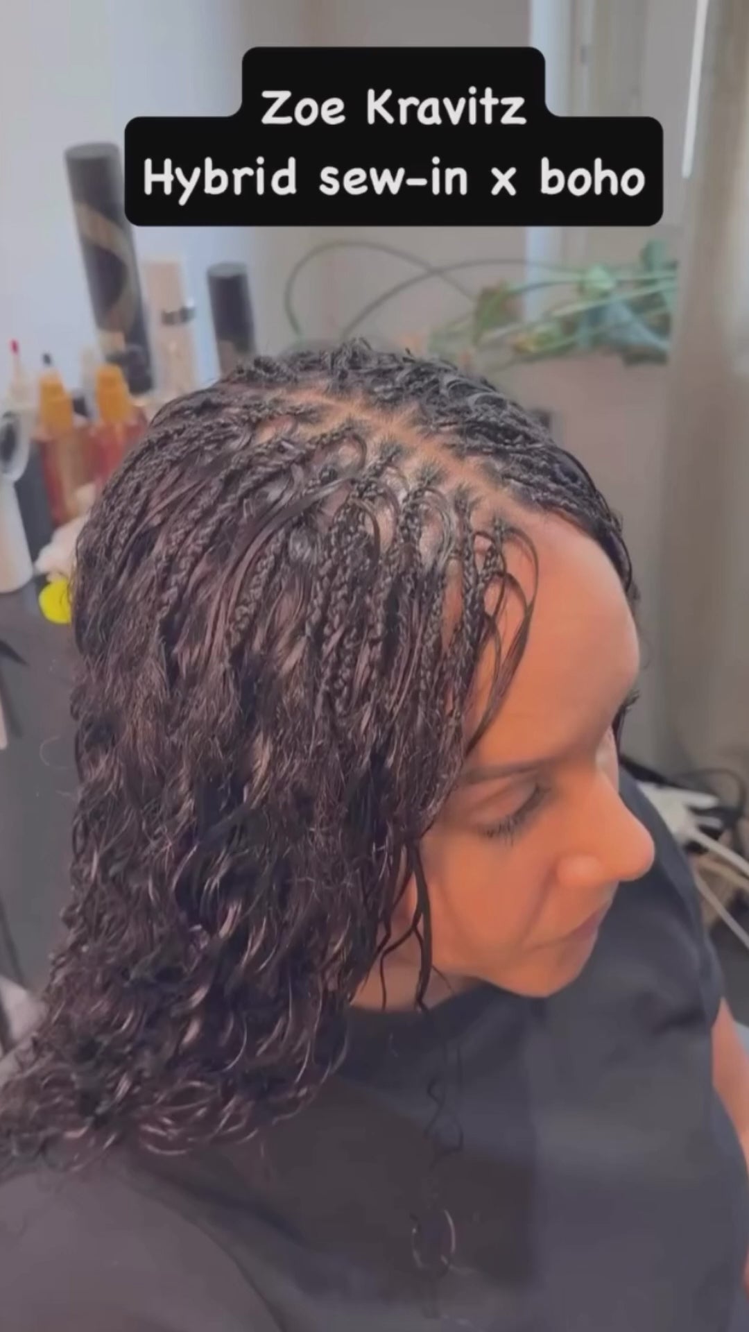 lady getting braided she is wearing a half weave and boho braids using wavy human hair from crown royale hair hair bundles 